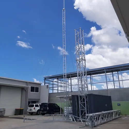 AL340 14m tripod lattice tower beside the Hinged Container Tower